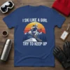 T-shirt with text "I Ski Like A Girl Try To Keep Up" featuring a female skier jumping over mountains at