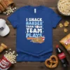 I SNACK HARDER THAN YOUR TEAM PLAYS text with baseball graphic and snacks illustration on a royal blue t-shirt