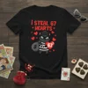 T-shirt design with red text "i steal 67 HEARTS" and a cartoon cat burglar holding a heart with "67" on