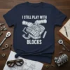 I Still Play With Blocks T-Shirt featuring a detailed engine graphic and bold text, ideal for mechanics and car enthusiasts