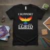 Black t-shirt with white text "I SUPPORT LGBTQ" and a rainbow-colored dove graphic