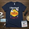 Navy blue t-shirt with "I Survived 2020" text and graphic depicting a strong arm, yellow hexagon, and stars
