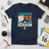 I Survived Tax Season t-shirt design featuring distressed typography and a graphic of a person kneeling next to a document