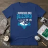 I SURVIVED THE BLIZZORD OF '26 text on a navy blue t-shirt with a mountain and snowflake graphic