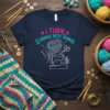 I Turn Strings Into Things quote with sewing machine graphic and colorful yarn on a navy t-shirt