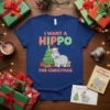 I Want A Hippo For Christmas t-shirt design with a cute cartoon hippo, Christmas tree, presents, and teddy bear