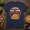 I Want 'Em Real Thick And Juicy text with a cartoon roasted turkey graphic on a navy blue t-shirt