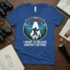 I Want To Believe (Bigfoot Edition) t-shirt featuring Bigfoot, a UFO, and a forest scene under a starry night sky
