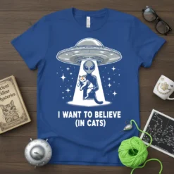 Blue t-shirt with "I Want To Believe (In Cats)" text, featuring an alien abducting a cat with a UFO and