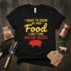 Black t-shirt with yellow and red text "I Want To Grow My Own Food I Can't Find Bacon Seeds" and