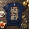 Navy blue t-shirt with "I WAS 66 NOW I'M 67" text in orange and leopard print numbers, celebrating a 67th