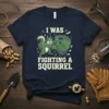 I Was Fighting A Squirrel text with cartoon squirrel and baseball glove design on a navy t-shirt