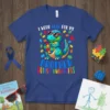 Dinosaur wearing sunglasses holding an autism puzzle heart, text "I Wear Blue For My Brother Autism Awareness"