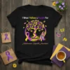 T-shirt with text "I Wear Yellow & Purple For Autoimmune Hepatitis Awareness," featuring a purple and yellow tree, gnome, and