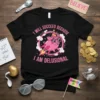 Black t-shirt with pink text "I Will Succeed Because I Am Delusional" featuring a cartoon pig in a party hat