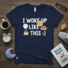Navy blue t-shirt with "I Woke Up Like This :)" text, a cartoon sun, cup of coffee, and pancakes graphic