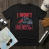 Black t-shirt with "I WON'T DO WHAT YOU TELL ME" text and a graphic of a semi-truck in motion
