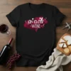 Black t-shirt with white text "I ON CLOUD WINE" inside a pink cloud graphic, featuring wine glasses and grapes