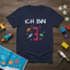 Navy blue t-shirt with white text "Ich BIN 3" and a cartoon rocket, planets, and stars graphic for a 3rd