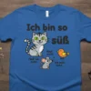 German "Ich Bin So Süß" t-shirt featuring a cute tabby cat, a mouse, and a bird, with playful text dialogue