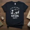 T-shirt with German text "Ich mag halt einfach.. KATZEN. OKAY?" and cartoon cats playing with yarn