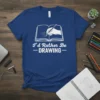 I'd Rather Be DRAWING text with open book and hand holding pencil graphic on blue t-shirt