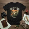 I'd Rather Be Hunting graphic t-shirt design featuring a hunter aiming a rifle at a deer in a forest scene