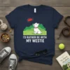 I'd Rather Be With My Westie t-shirt featuring a cute West Highland White Terrier sitting in grass with a frisbee