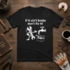 If it ain't broke don't fix it quote on a black t-shirt with a cartoon wrench character and a faucet