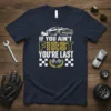 T-shirt with "IF YOU AIN'T FIRST YOU'RE LAST" text, racing car graphic, and checkered flags