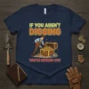 If You Aren't Digging You're Missing Out quote on a navy t-shirt with a graphic of a treasure hunter finding