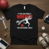 If You Can Dodge A Wrench You Can Dodge A Ball quote on a black t-shirt featuring a cartoon mechanic