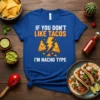 Blue t-shirt with text "IF YOU DON'T LIKE TACOS I'M NACHO TYPE" and cartoon nachos with a lightning bolt
