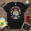 Teacher appreciation t-shirt with "If You Give Me A I Will Love Them" quote, stack of books, and apple graphic