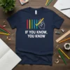 Navy t-shirt with white text "IF YOU KNOW, YOU KNOW" and a graphic of colored lines and a hand with