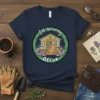 I'll be in my Office T-Shirt with a cute illustration of a garden shed, books, laptop, and flowers