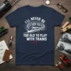 I'll Never Be Too Old to Play With Trains quote on a navy t-shirt with a modern train graphic and