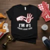 Black t-shirt with white text "I'M #1 FINGER LICKIN' GOOD" and a graphic of two hands indicating the number 6