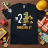 T-shirt with "I'm 2 And Digging It" text, featuring a cartoon dinosaur in a construction helmet operating an excavator, perfect