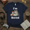 I'm Bored t-shirt featuring a chubby cat sitting with a phone surrounded by snacks and headphones