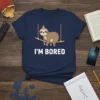 Navy blue t-shirt with "I'M BORED" text and a cartoon sloth hanging on a branch, wearing a party hat