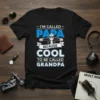 Black t-shirt with blue and white text reading "I'm Called Papa Because Cool To Be Called Grandpa" and a graphic