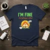 I'm Fine Everything Is Fine t-shirt with a cartoon house on fire and a coffee cup watering it