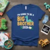 I'm Going To Be A Big Brother 2026 text with a cute dinosaur on a blue t-shirt
