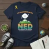 Navy blue t-shirt with "I'm Hanging With NED No Evidence of Disease" text and a cloud character on mountains, featuring