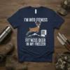 I'M INTO FITNESS FIT'NESS DEER IN MY FREEZER quote on a navy t-shirt with a deer jumping over mountains and