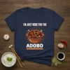 Navy t-shirt with "I'm Just Here For The Adobo" text and a graphic of a bowl of adobo chicken