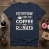 Navy blue t-shirt with white text "I'm Just Here For The Coffee And Donuts" and graphics of a coffee cup