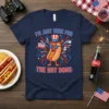 I'm Just Here For The Hot Dogs t-shirt design with a patriotic cartoon hot dog character holding American flags and