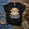 Black t-shirt with "I'm Just Here For The Snuggles" text and a cute peeking dog graphic